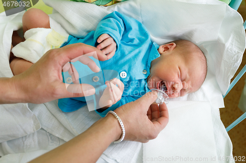 Image of crying newborn baby infant in the hospital