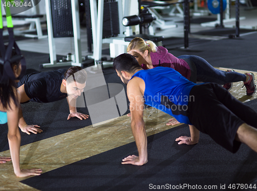 Image of young healthy people doing pushups