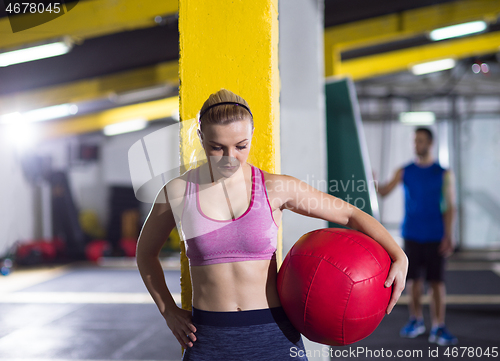 Image of portrait of woman with red crossfitness ball