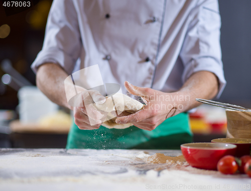 Image of chef hands preparing dough for pizza