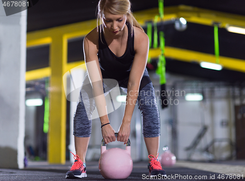 Image of woman exercise with fitness kettlebell