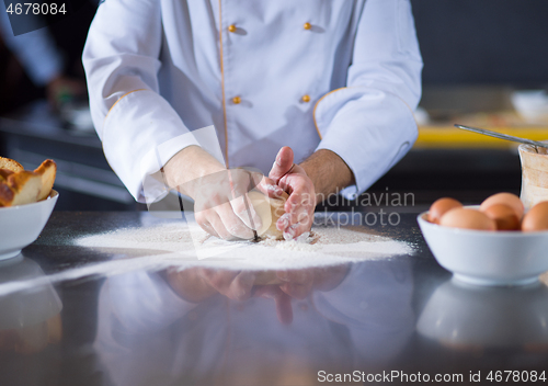 Image of chef hands preparing dough for pizza