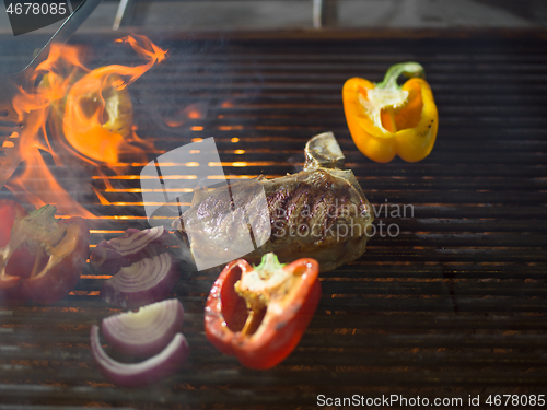 Image of steak with vegetables on a barbecue