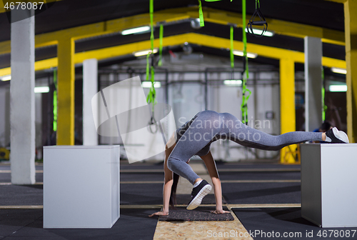 Image of woman working out gymnastic exercise on fit boxes