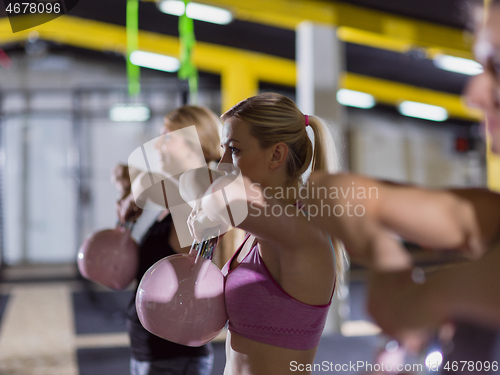 Image of athletes doing exercises with kettlebells