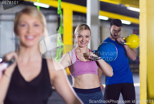 Image of athletes doing exercises with kettlebells