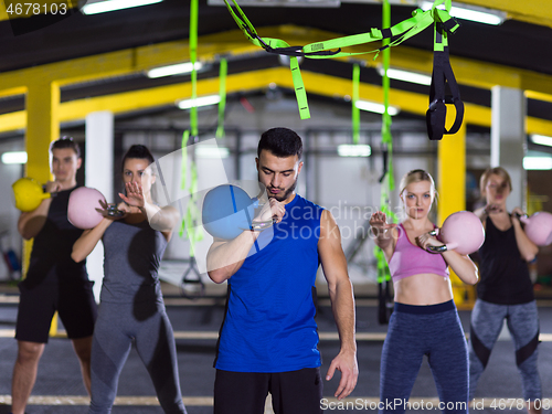 Image of athletes doing exercises with kettlebells