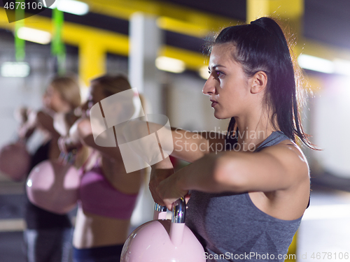 Image of athletes doing exercises with kettlebells