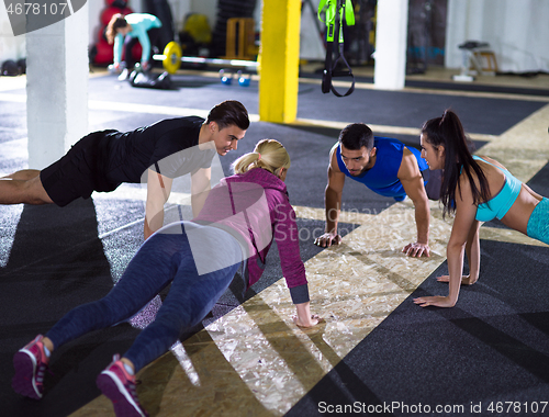 Image of young healthy people doing pushups