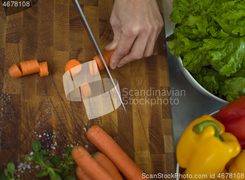 Image of chef hands cutting carrots