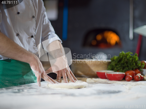 Image of chef preparing dough for pizza