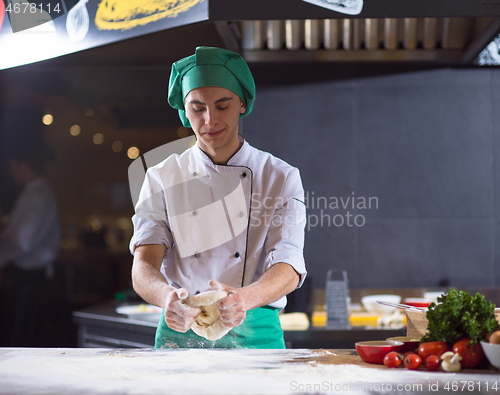 Image of chef hands preparing dough for pizza