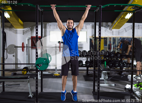 Image of man doing pull ups on the horizontal bar