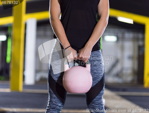 Image of woman exercise with fitness kettlebell