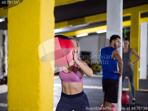 Image of young athletes working out with medical ball