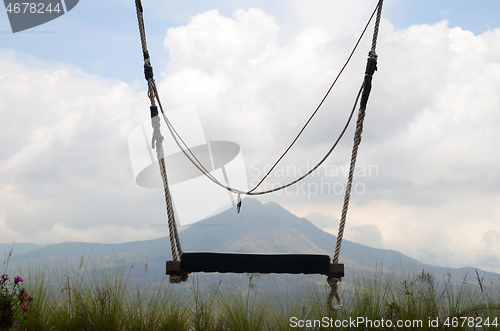Image of Wooden swing on the rope with view of Batur volcano