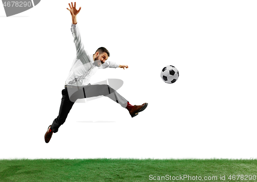 Image of Full length shot of a young businessman playing football isolated on white background