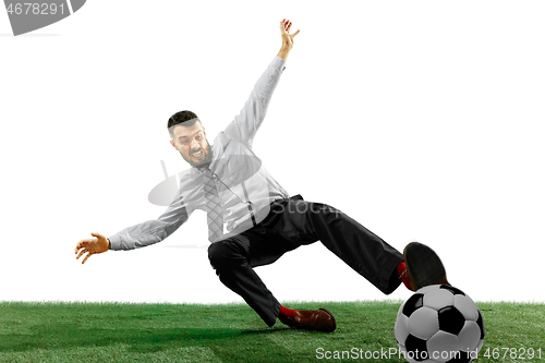 Image of Full length shot of a young businessman playing football isolated on white background