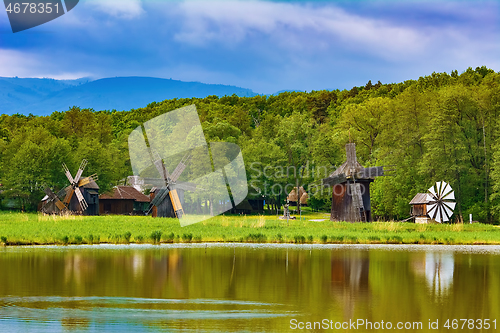 Image of Windmills on the Bank of Lake