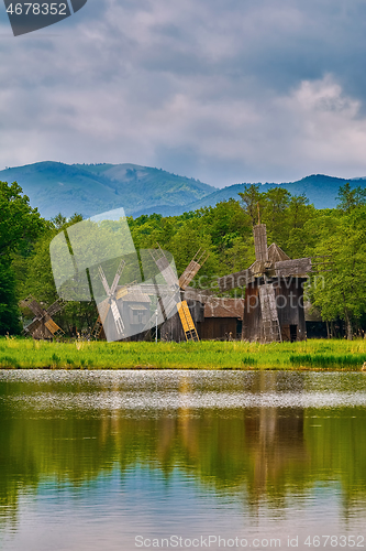 Image of Windmills on the Bank of Lake