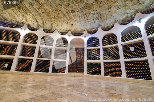 Image of Old wine bottles and old doors in winery