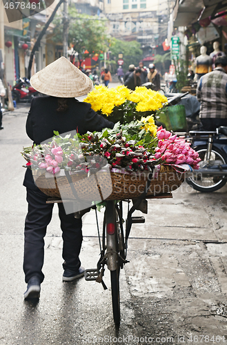 Image of Woman selling flowers on the street in Hanoi, Vietnam