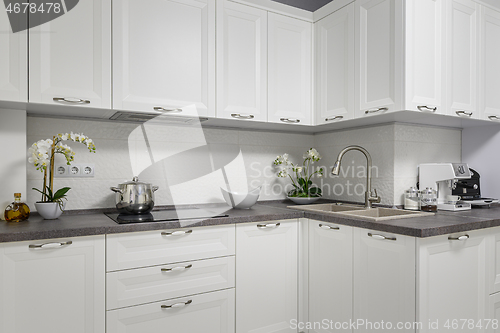 Image of Clean and minimalistic modern white kitchen interior