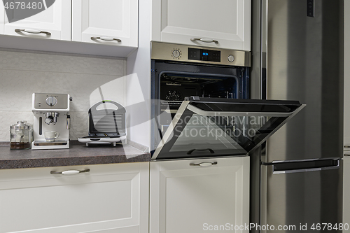 Image of Electric appliances in minimalistic white kitchen interior