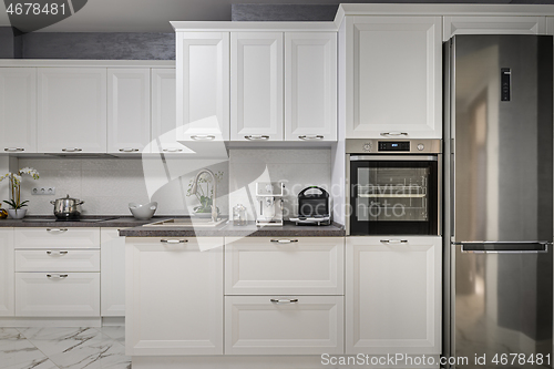 Image of Electric appliances in minimalistic white kitchen interior