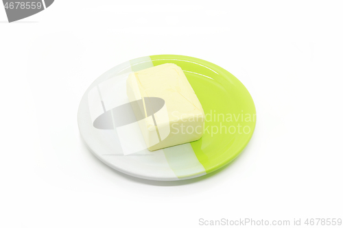 Image of Piece of butter on a two-color plate