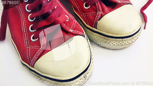 Image of Old crimson sneakers, close-up