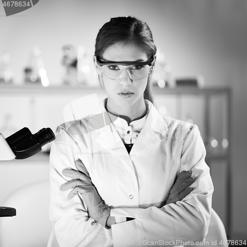 Image of Portrait of a attractive, young, confident female health care professional in hes working environment. Black and white image