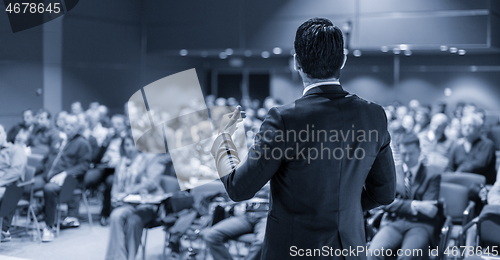 Image of Speaker giving a talk at business conference meeting.