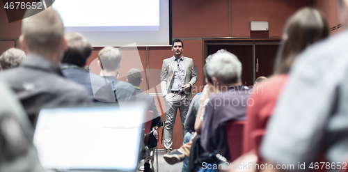 Image of Business speaker giving a talk at business conference meeting event.