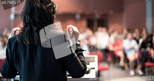 Image of Public speaker giving talk at Business Event.