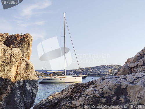 Image of Sailboat mooring in a small cove of beach Velo Zarace on Hvar island, Croatia in sunset