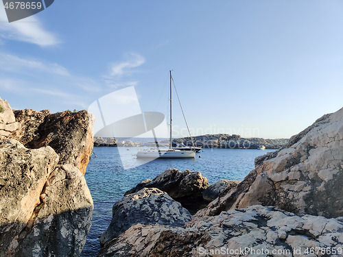 Image of Sailboat mooring in a small cove of beach Velo Zarace on Hvar island, Croatia in sunset