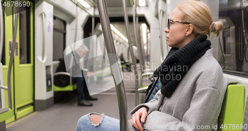 Image of Portrait of lovely girl commuting on almost empty public subway train. Staying at home and social distancing recomented due to corona virus pandemic outbreak.