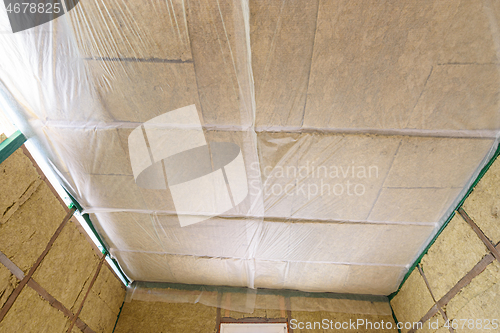 Image of Insulated ceiling of a country house, insulation is closed with a vapor barrier film