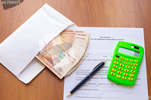 Image of The concept of signing a purchase and sale agreement for a land plot