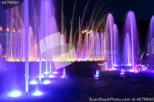 Image of Jets of a night multi-colored illuminated fountain close-up