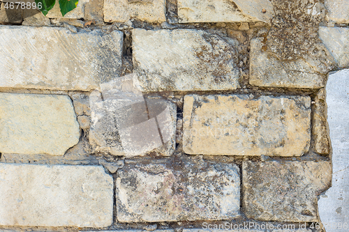 Image of Old block wall with peeling a plaster