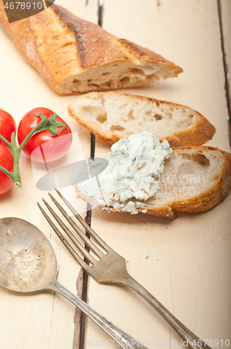 Image of fresh blue cheese spread ove french baguette