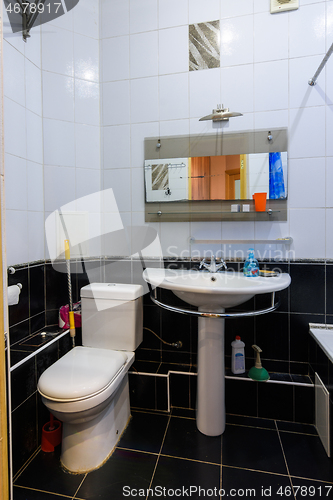 Image of Classic bathroom interior in an apartment for daily rent, view of the toilet and washbasin