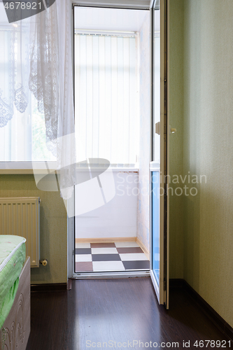 Image of Exit from the room to the glazed balcony in the apartment