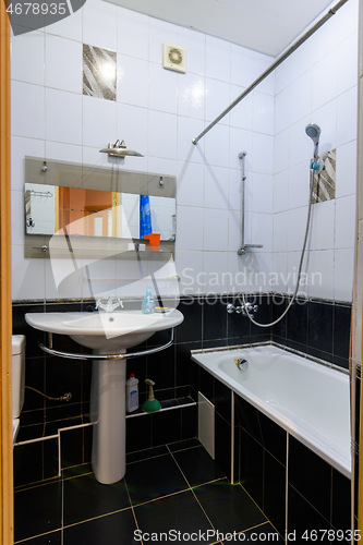 Image of Classic bathroom interior in an apartment, with black and white tiles