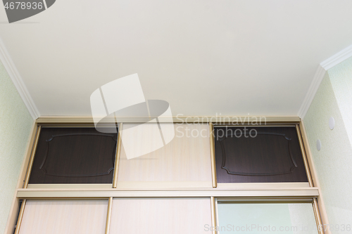 Image of The mezzanine of the wardrobe close-up in the interior of the bedroom