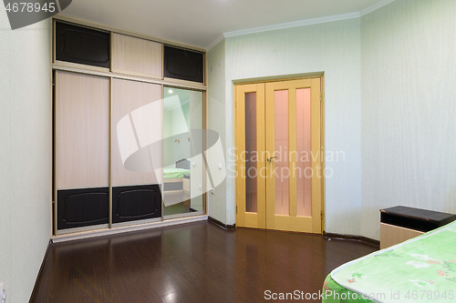 Image of Fragment of the bedroom interior, view of the wardrobe and the interior door