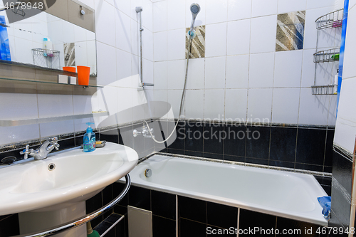 Image of Classic bathroom interior in an apartment for daily rent, view of the bathroom and washbasin