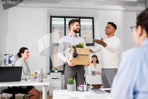 Image of new male employee meeting colleagues at office